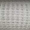 A close-up view of thin, white plastic mesh with a grid pattern.