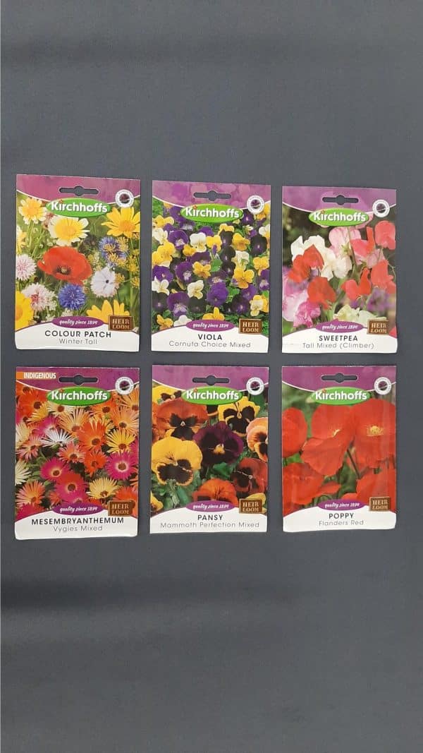 Six packets of a variety of Kirchhoffs flower seeds against a black background.