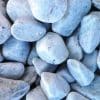 Smooth, rounded grey pebbles of varying sizes piled closely together.