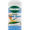 White bottle of Seagro organic plant food, with a birds of paradise illustration on the front.