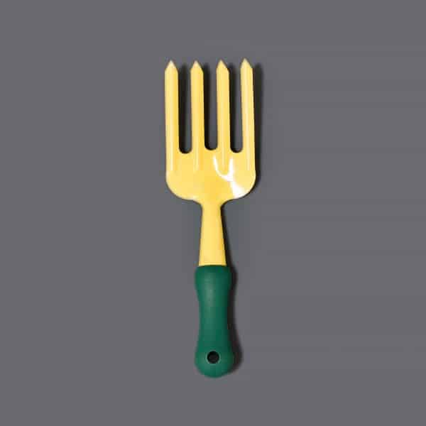 A small yellow gardening fork with a green handle.